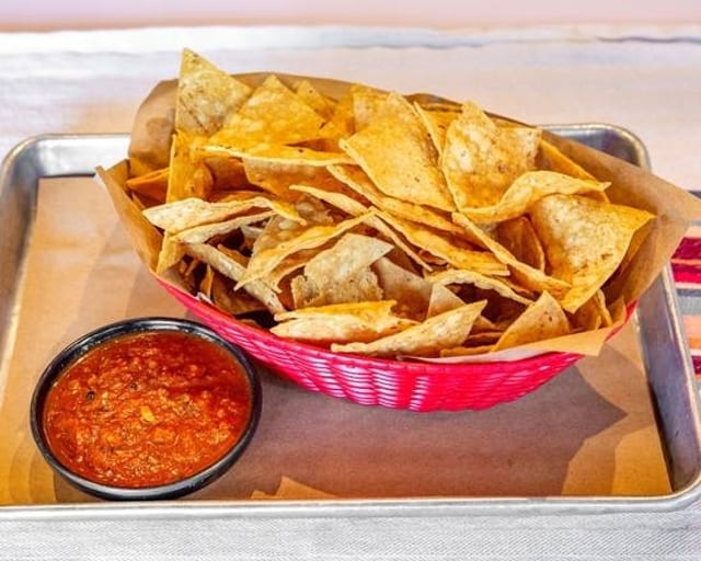 Sides & Botanas - House-made chips with Salsa Roja.
